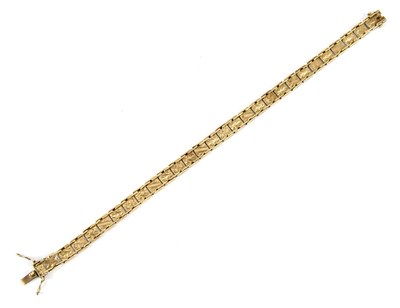 Lot 570 - A yellow metal articulated bracelet with...