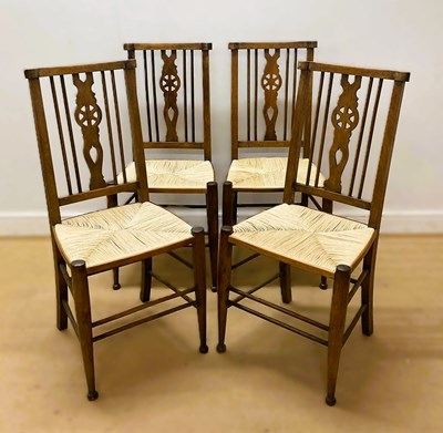 Lot 592 - ARTS & CRAFTS; a set of four light oak wheel...