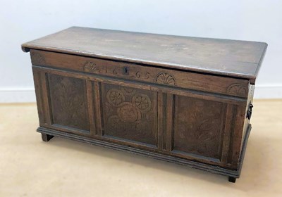 Lot 674 - An oak blanket box with carved panels and...