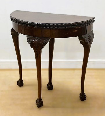 Lot 668 - A mahogany circular fold-over card table with...