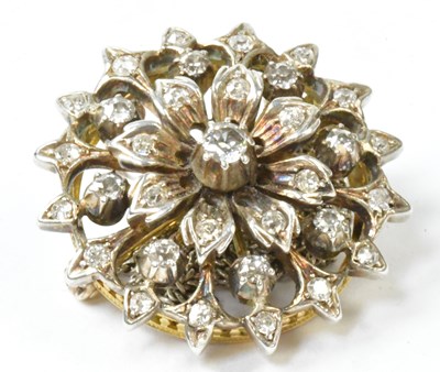 Lot 790 - A white and yellow metal circular floral...