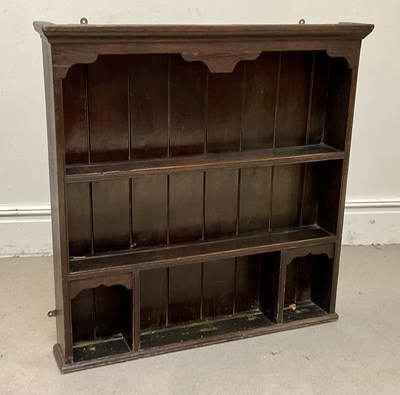 Lot 60 - An early 20th century oak hanging plate rack,...