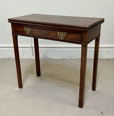 Lot 115 - A late George III mahogany fold-over tea table,...