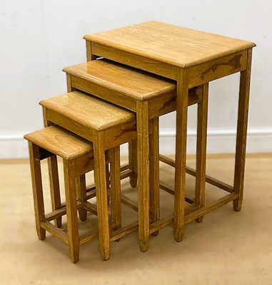 Lot 624 - A set of four light oak nest of tables, height...