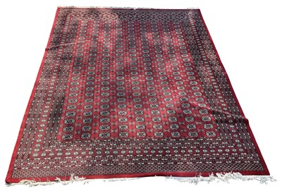 Lot 156 - A large modern red ground hand woven Pakistani...