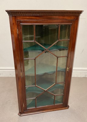 Lot 162 - A George III mahogany hanging corner cabinet,...
