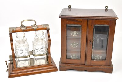 Lot 354 - A mahogany smoker's cabinet with two glazed...