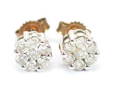 Lot 597 - A pair of diamond earrings in yellow metal...