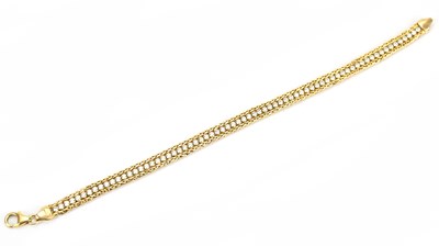 Lot 575 - A yellow metal bracelet set with clear stones,...