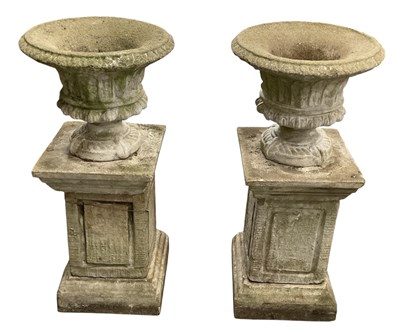 Lot 219 - A pair of composite stone classical style urns...