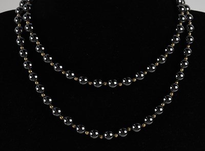 Lot 1473 - A black metallic bead single strand necklace,...