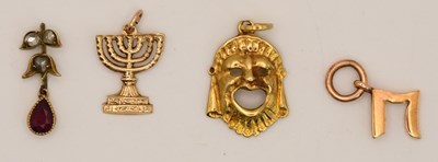 Lot 1548 - A 14K yellow gold bracelet charm modelled as a...