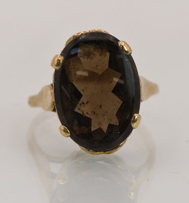 Lot 1407 - A 9ct yellow gold smoky quartz set solitaire...