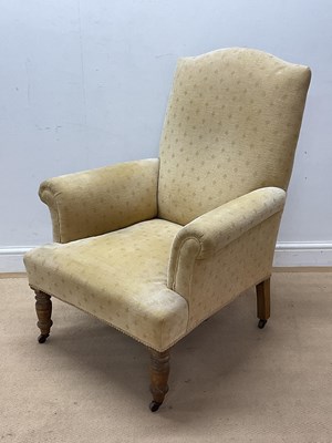 Lot 617 - An upholstered high back armchair with turned...
