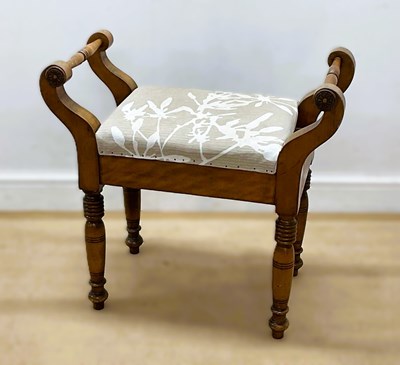 Lot 648 - A beech framed piano stool with lift up seat...