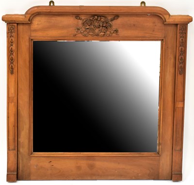 Lot 55 - A pine overmantel mirror with carved flower...