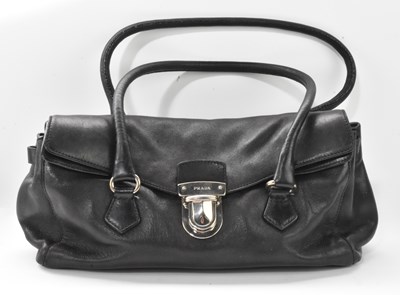 Lot 675 - PRADA; a vintage black leather lady's handbag,...