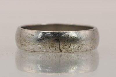 Lot 1406 - A 9ct white gold band ring, size W, approx 7.33g.