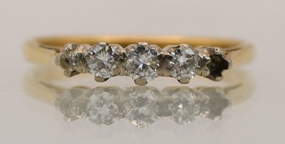 Lot 1400 - An 18ct yellow gold diamond five stone ring...