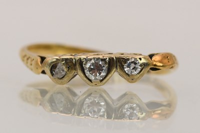 Lot 1405 - An 18ct yellow gold diamond three stone ring...