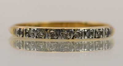 Lot 1423 - An 18ct yellow gold diamond set half eternity...
