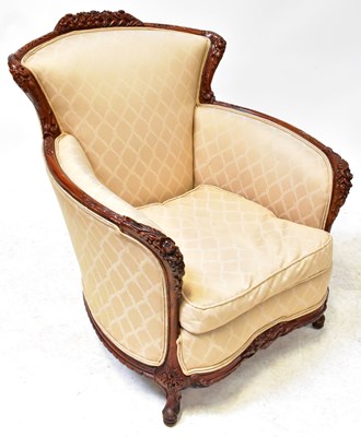 Lot 30 - A Victorian style walnut tub armchair with...