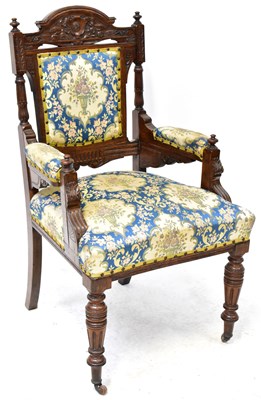 Lot 43 - An Edwardian oak carved open elbow chair with...
