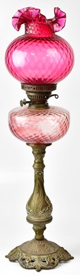 Lot 68 - A Victorian style oil lamp with cranberry...