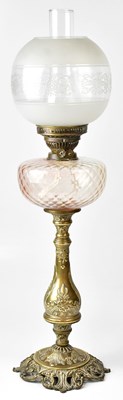 Lot 69 - A Victorian style oil lamp with cranberry...