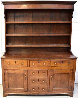Lot 15 - A George III oak dresser, with an enclosed...