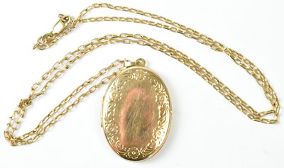 Lot 808 - A 9ct yellow gold oval locket with floral and...