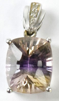 Lot 801 - A 9k white gold pendant set with a pale purple...