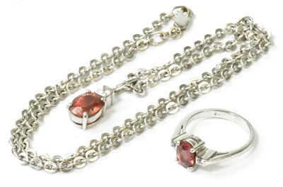 Lot 764 - An 18ct white gold ring set with central pink...