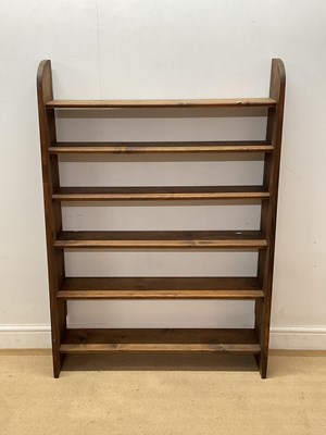 Lot 626 - A stained pine book shelf with six shelves,...