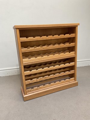 Lot 41 - A light oak wine rack, on plinth base, height...