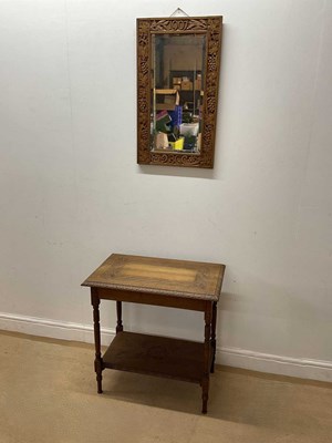 Lot 673 - An Arts & Crafts carved oak wall mirror with a...