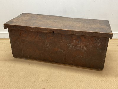 Lot 664 - An oak coffer with carved detail to the front,...