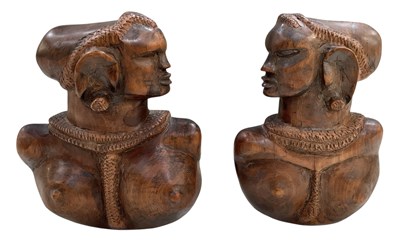 Lot 1069 - A pair of African carved wooden tribal...
