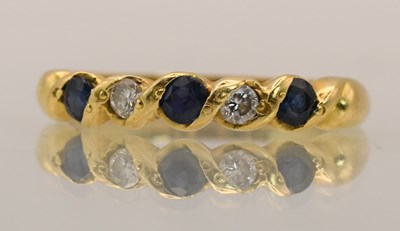 Lot 1384 - An 18ct yellow gold diamond and sapphire...