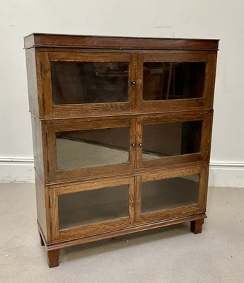 Lot 120 - MINTY; an oak three section bookcase, with...
