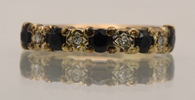 Lot 1437 - A 9ct diamond and sapphire set ring, size O,...