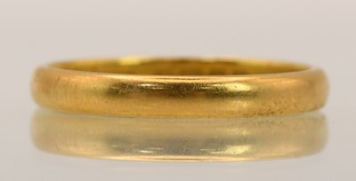 Lot 1360 - A 22ct yellow gold band ring, size O, approx 6....