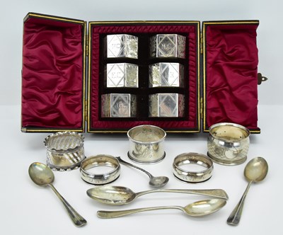 Lot 1095 - A cased set of six near matching napkin rings...
