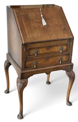 Lot 135 - A 1930s walnut bureau of small proportions,...