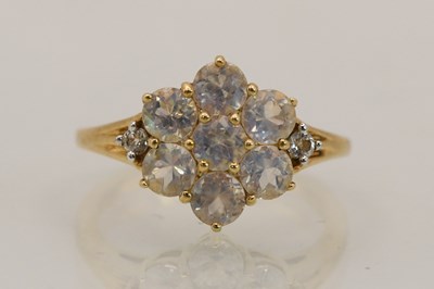 Lot 1447 - A 9ct yellow gold moonstone cluster ring, the...