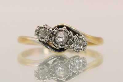 Lot 1382 - An 18ct yellow gold three stone diamond set...