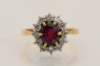 Lot 1376 - An 18ct yellow gold diamond and ruby set ring,...