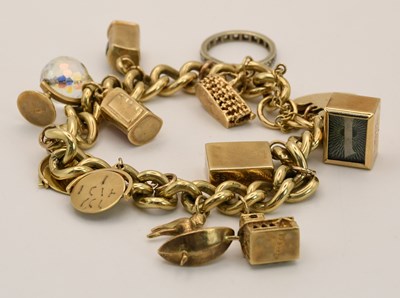 Lot 1533 - A 9ct yellow gold charm bracelet, with ten...