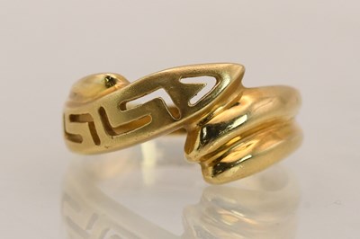 Lot 1394 - An unmarked gold ring with Greek key crossover...