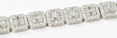 Lot 780A - An 18ct white gold articulated tennis bracelet,...